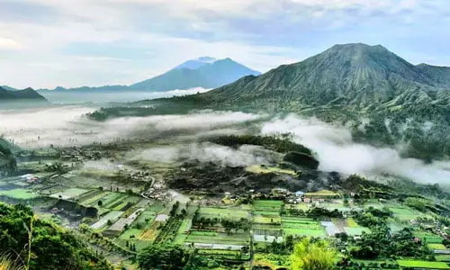 Scenic view of Pinggan Village in Kintamani with Mount Batur in the background โ included in Bali tour packages itinerary
