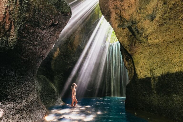 Woman enjoying the water at Tukad Cepung Waterfall