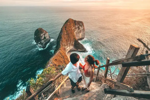 Couple enjoying scenic view at Kelingking Beach, part of Bali Tour Packages for Couples