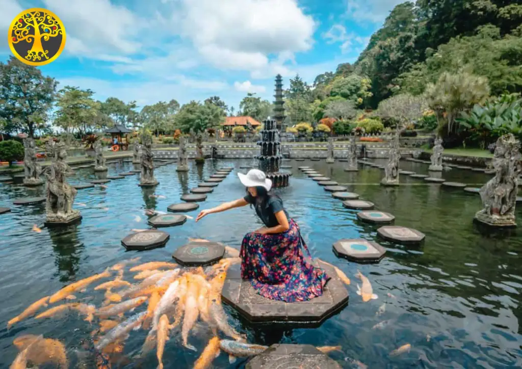 Woman walking on stepping stones at Tirta Gangga Water Palace, a serene highlight in Bali tour packages