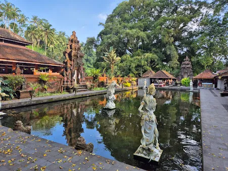 Pura Tirta Empul temple with holy spring water and traditional Balinese statues, a spiritual highlight in Bali tour packages.