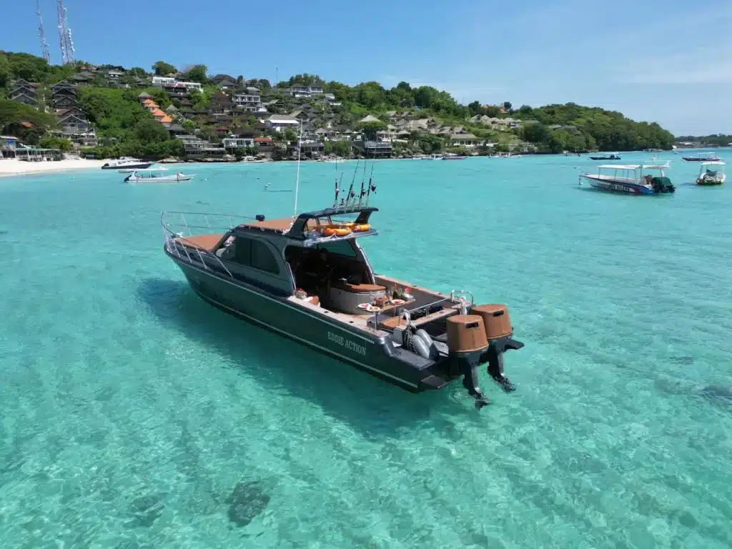 Private South Bali Fishing Tour boat anchored in clear turquoise waters, part of an unforgettable Bali day tour experience.