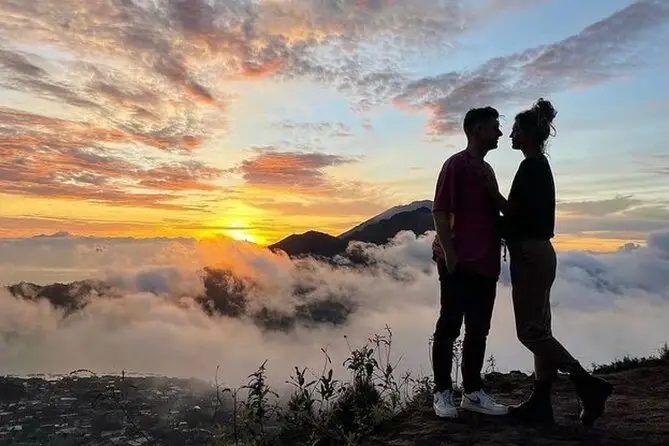 Bali couple tour enjoying sunrise together at Mount Batur.
