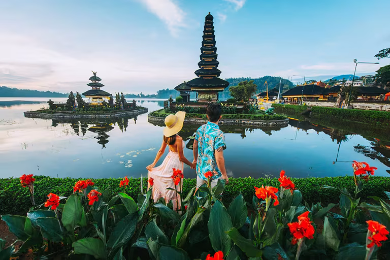 Iconic Bali couple tour at Ulun Danu Temple with scenic backdrop.