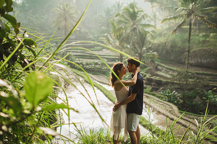 Bali couple tour capturing romantic moments in lush rice terraces.