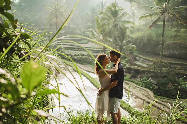 Bali couple tour capturing romantic moments in lush rice terraces.