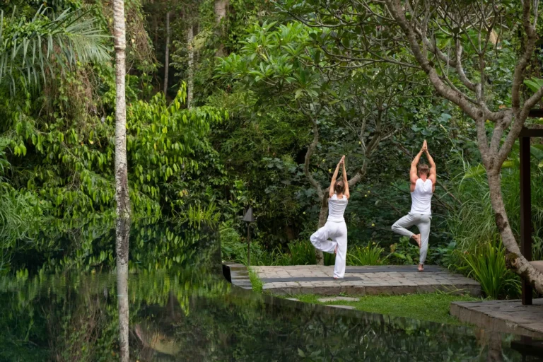 Couple practicing yoga in nature during Wellness and Yoga Tours in Bali