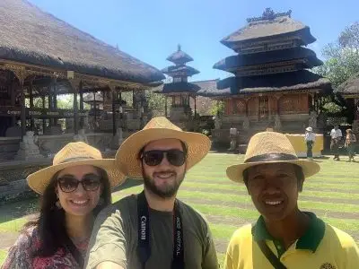 Agung Bali tour guide accompanying travelers to traditional temples in Bali