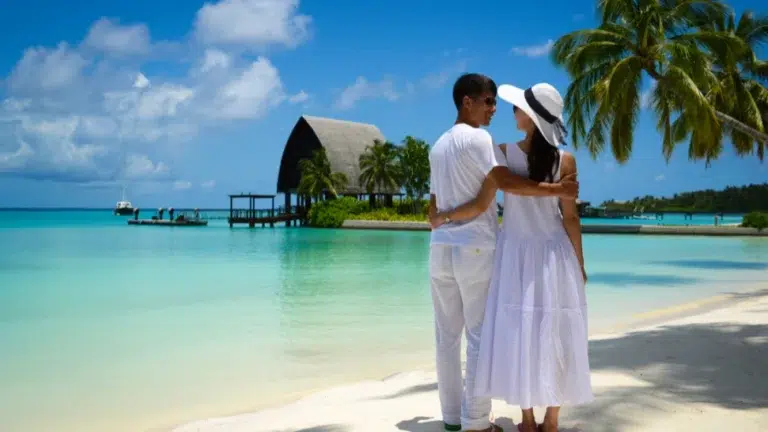 Couple enjoying romantic beach view during sunset, part of Bali Honeymoon Packages experience