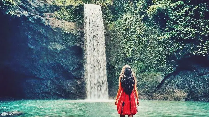 Exploring stunning waterfall view included in Tour Bali Package