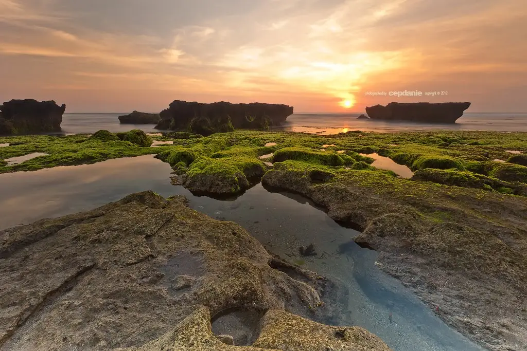 Tour operator in Bali offering sunset coastal tours with stunning rock formations.