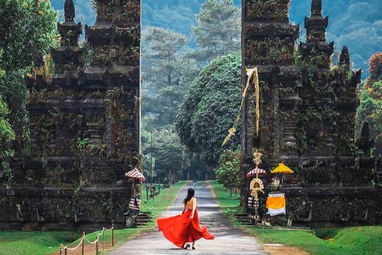 A traveler in a red dress exploring Handara Gate during a Flexible Bali Tour.