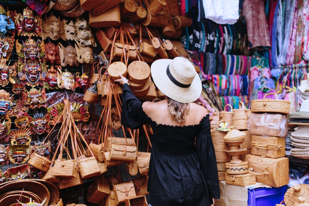 Woman browsing handmade crafts at a local Balinese market during a Flexible Bali Tour.