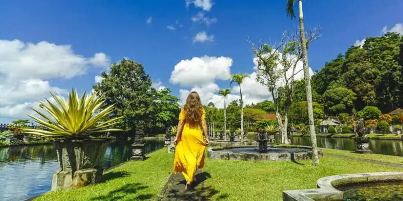ourist exploring a traditional Balinese temple garden on a Flexible Bali Tour.