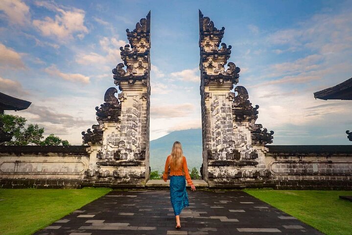Woman walking through the famous Handara Gate during a Flexible Bali Tour in Bali.