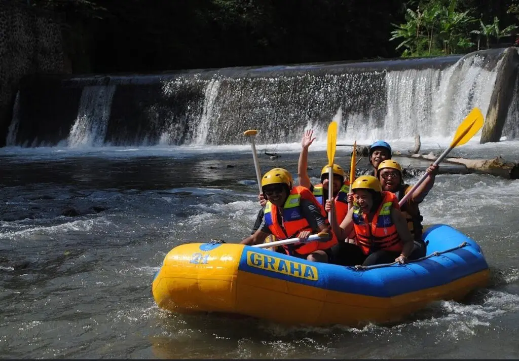 Group enjoying white water rafting in Bali river with Bali Adventure Tour experience.