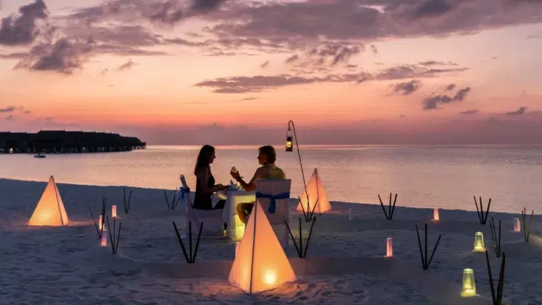 Romantic sunset beach setup included in a Bali honeymoon package for newlywed couples.