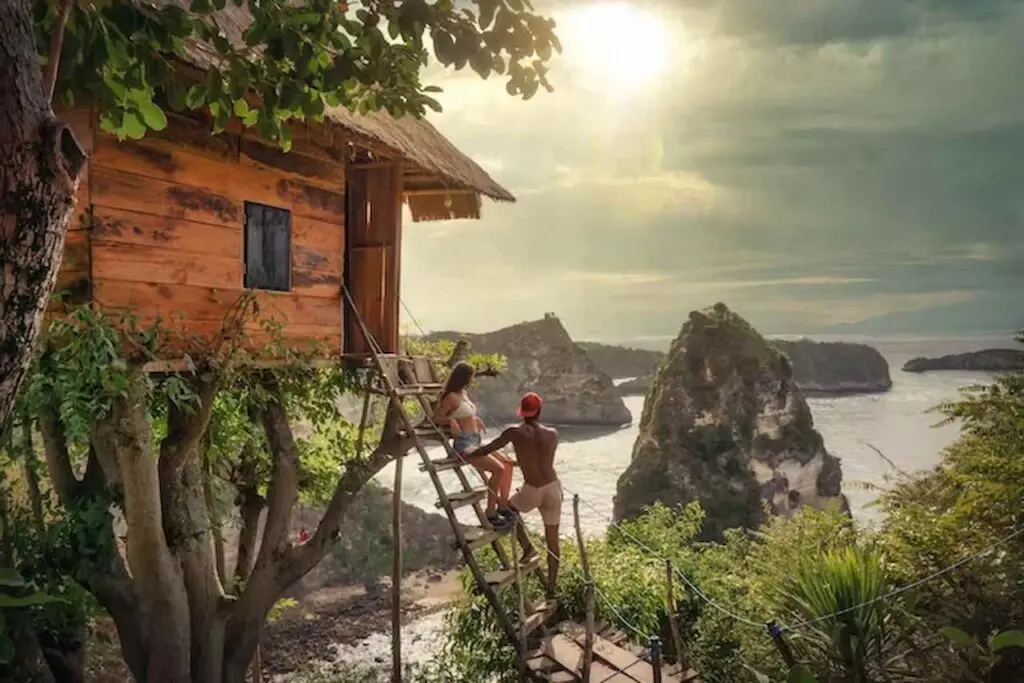 Romantic moment at a cliffside villa included in a Bali honeymoon package for couples seeking privacy.