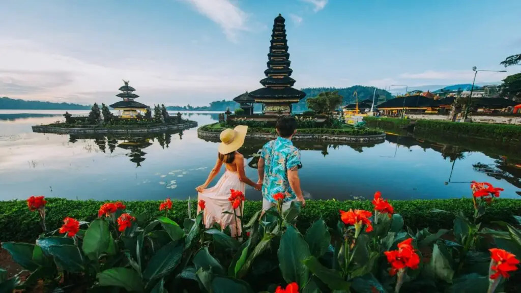 Couple visiting a famous Bali temple as part of a cultural itinerary in a Bali honeymoon package.
