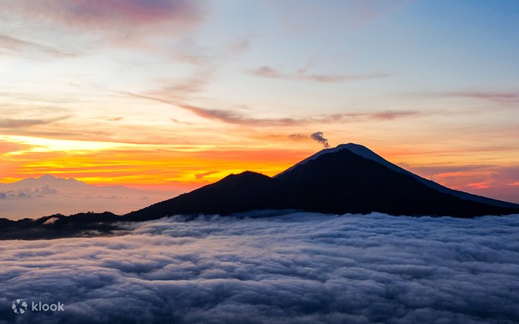 Sunrise trek to Mount Batur offering breathtaking views during Bali Day Tour adventure.